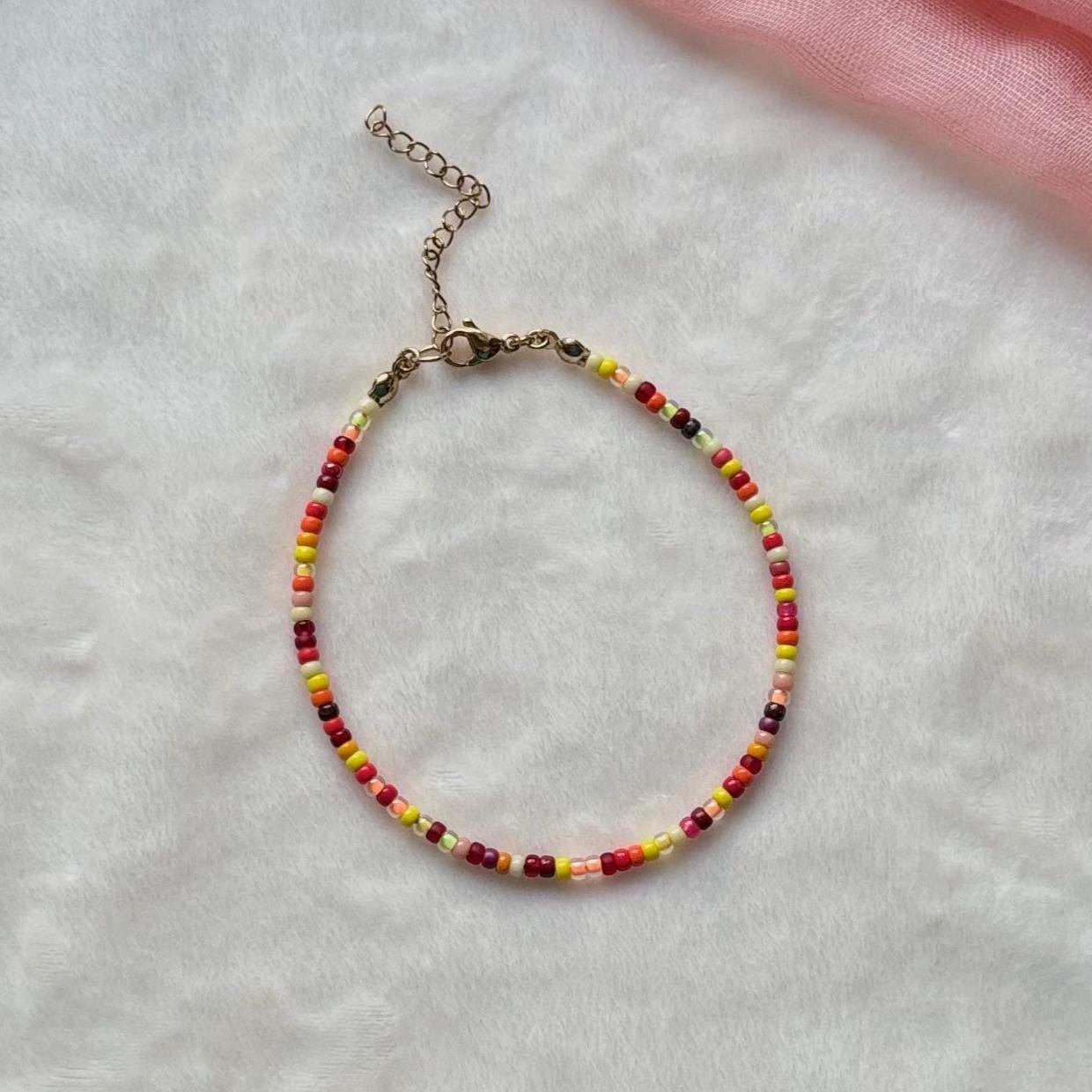 Beaded ankled on a light gray surface