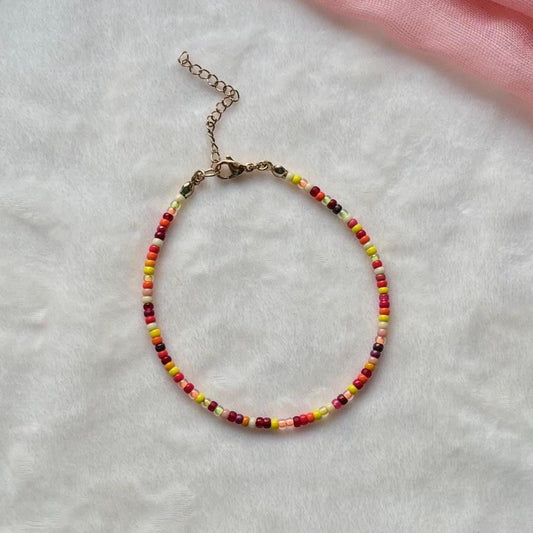 Beaded ankled on a light gray surface