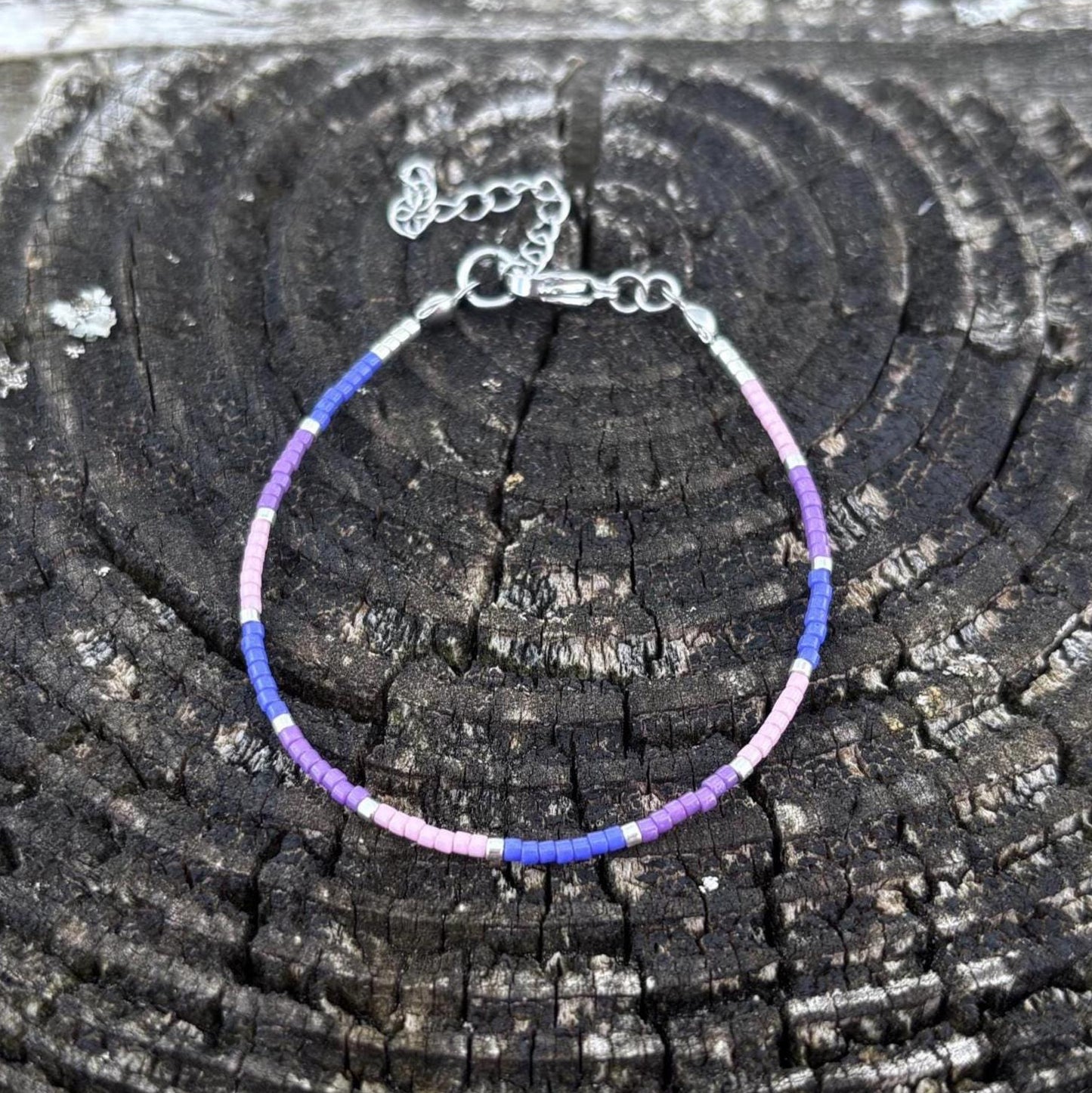 Bracelet with a gradient of purple and blue colors on a wooden surface