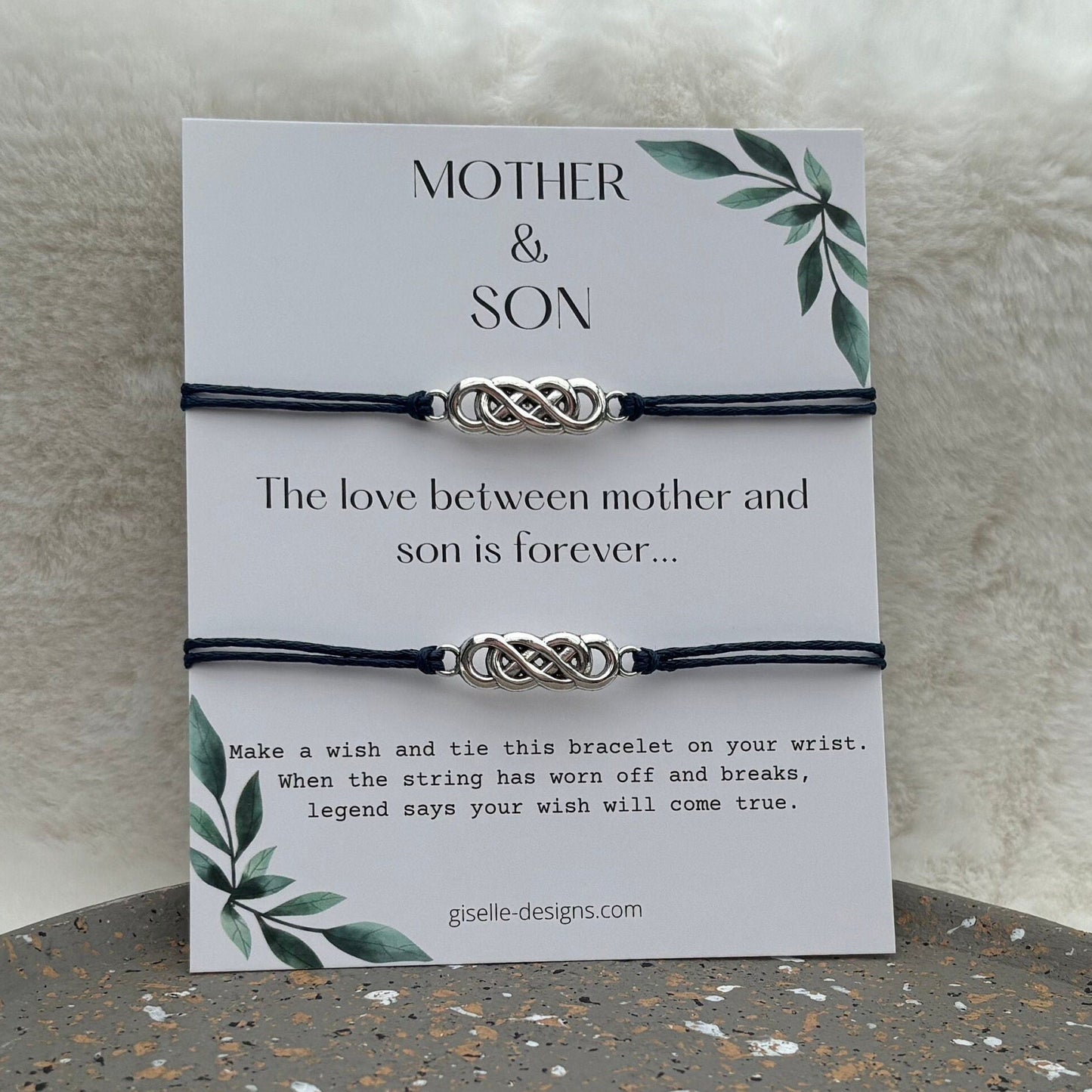 Bracelet with Celtic knot design on a card with text about mother and son love, on a textured surface.