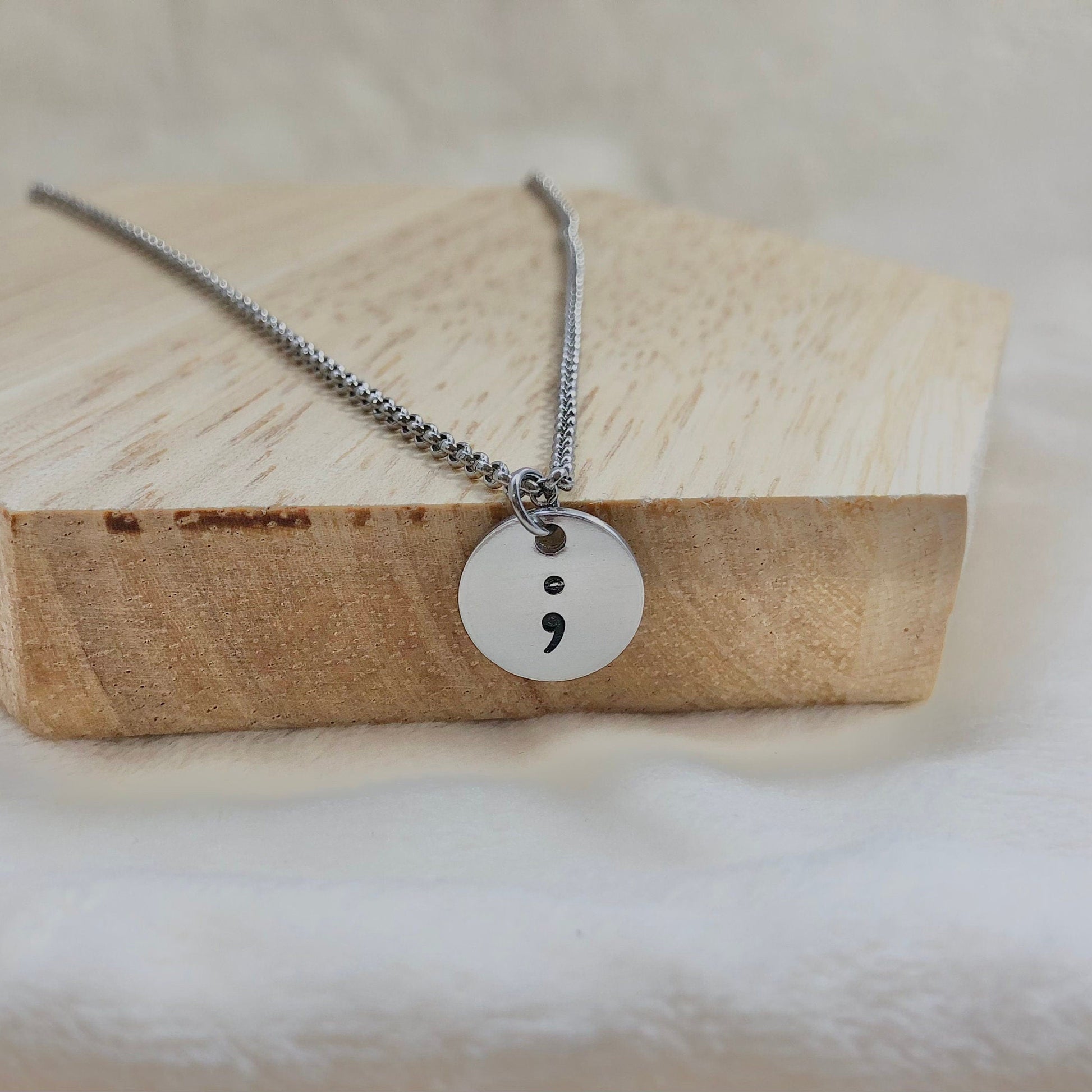 Necklace with a unique pendant on a wooden block