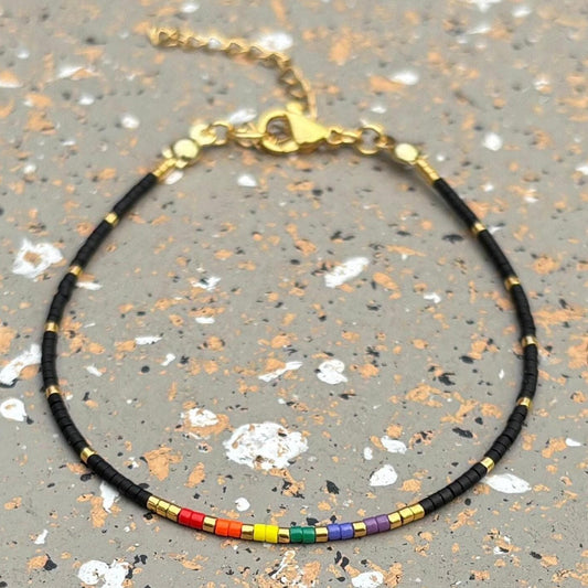 Bracelet with rainbow beads on a speckled surface
