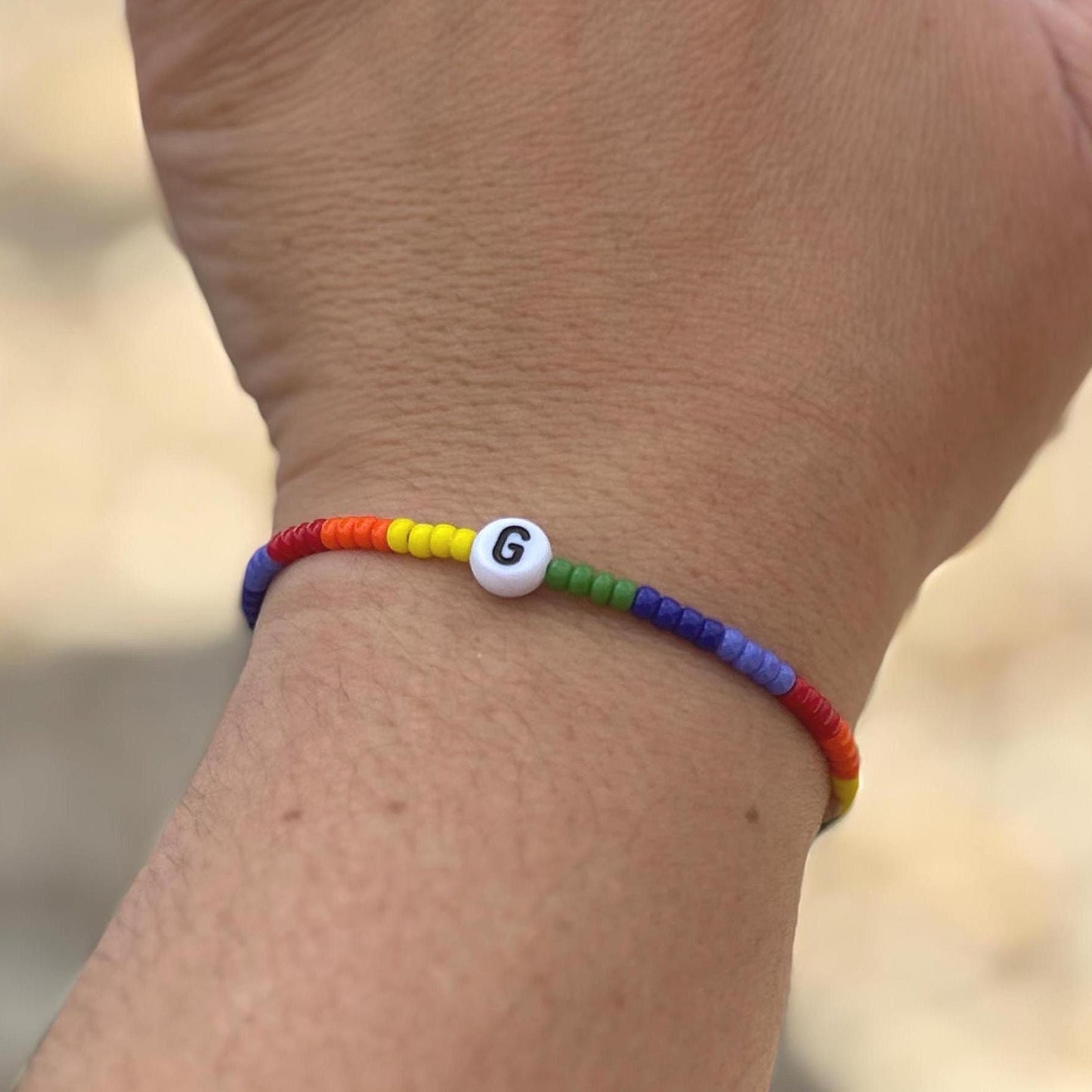 Colorful beaded bracelet on a wrist with a blurred background