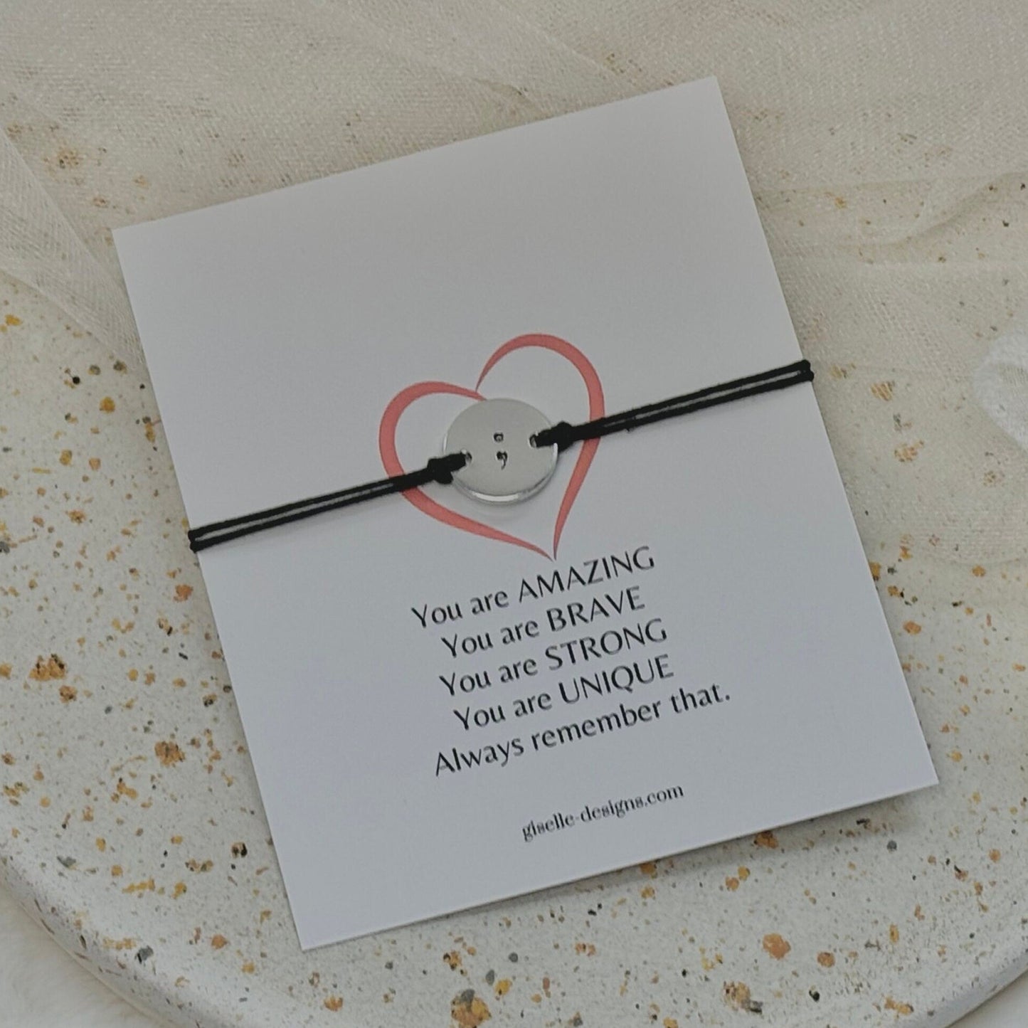Bracelet with inspirational message on a card on a textured surface